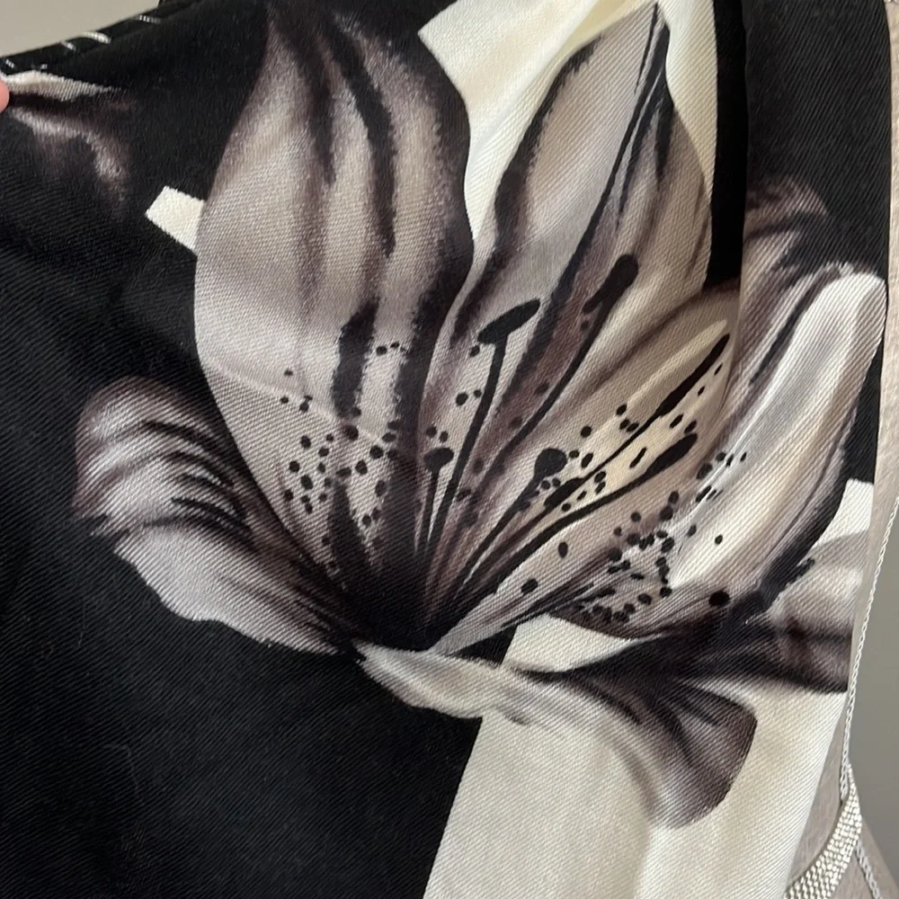Lightweight scarf/wrap.  Cream and black with floral details.  Fringe on the end